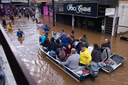 　川が氾濫し、ボートで避難する人々＝５日、ブラジル・ポルトアレグレ（ゲッティ＝共同）