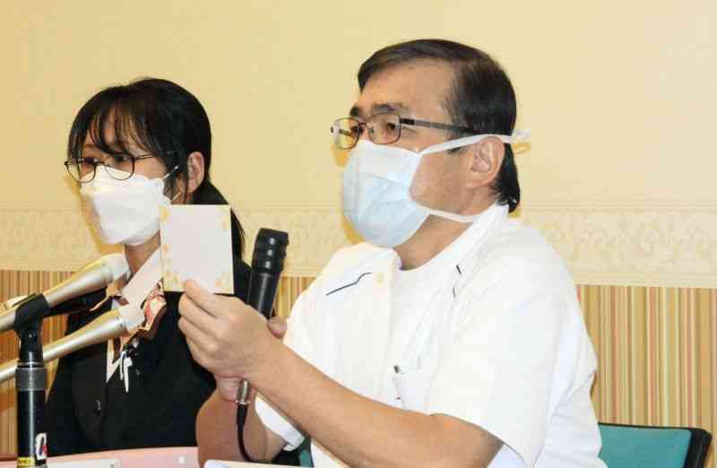後に内密出産の初事例となる出産について記者会見する慈恵病院の蓮田健院長（右）。女性が残した封筒を手にしている＝1月4日、熊本市西区