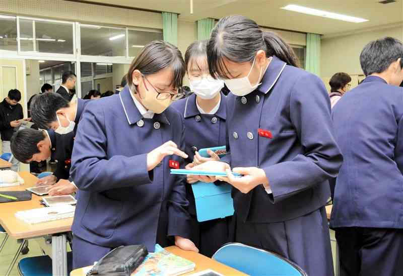 チャットGPTを使って、日本が戦争の道を進むことになった要因を探る生徒たち＝5日、熊本市北区の北部中