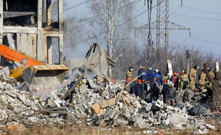 　ウクライナ東部ドネツク州マケエフカで破壊された建物のがれきを除去する作業員ら＝３日（ロイター＝共同）