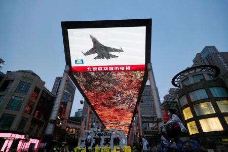 　中国軍が台湾周辺で実施した軍事演習についてのニュースを映す北京市内の大型画面＝２３日、北京（共同）