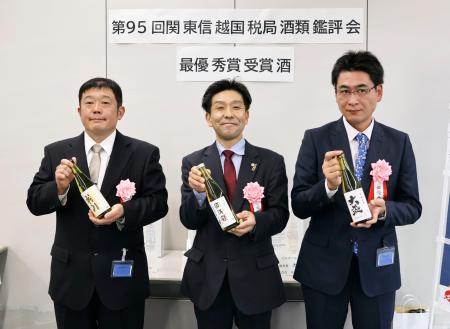 　関東信越国税局の酒類鑑評会で最優秀賞を受賞し、写真に納まる辻善兵衛商店の辻寛之代表兼杜氏（左）ら＝１４日午後、さいたま市