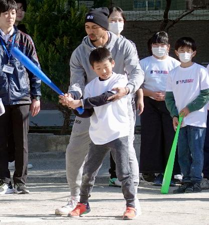 　野球体験イベントで児童に指導するドジャースのベッツ＝２２日、東京都内