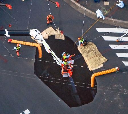 　道路が陥没した現場で続けられる救出作業＝２８日、埼玉県八潮市（共同通信社ヘリから）