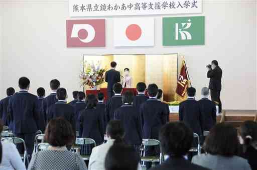 入学式で田中夏樹さんの新入生代表あいさつを聞く新入生や保護者ら＝八代市