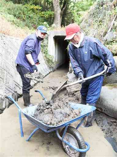 導水路を清掃する蒲生地区の住民たち。現在はコンクリートで補強され、作業もしやすくなっている＝山鹿市