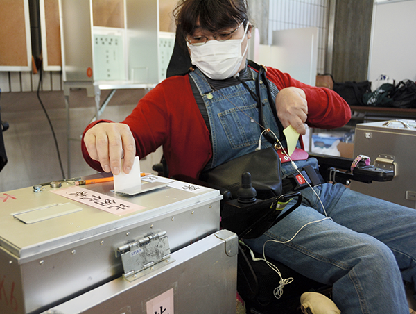 衆院選の期日前投票所で票を投じる田嵜ハヅキさん＝１０月２６日、熊本市北区