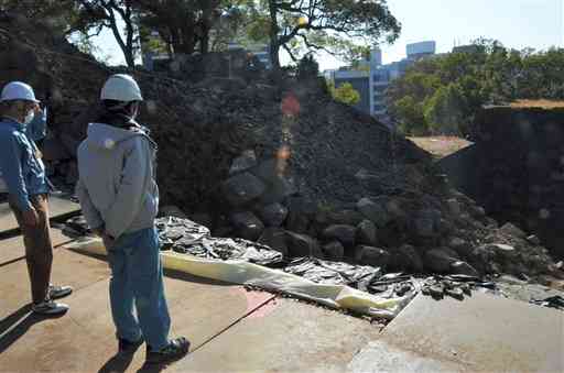 崩落石の回収作業が進められている竹の丸五階櫓台周辺の石垣＝１４日、熊本市中央区