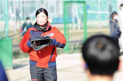 参加者にミットの構え方を指導する峰幸代捕手＝熊本市の城南総合スポーツセンター