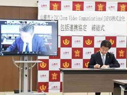 包括連携協定に署名する山鹿市の早田順一市長（右）とＺＶＣジャパンの佐賀文宣社長＝同市