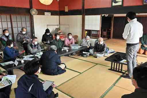 振動防除法の原理や効果などについて説明を聞くトマト農家ら＝山都町