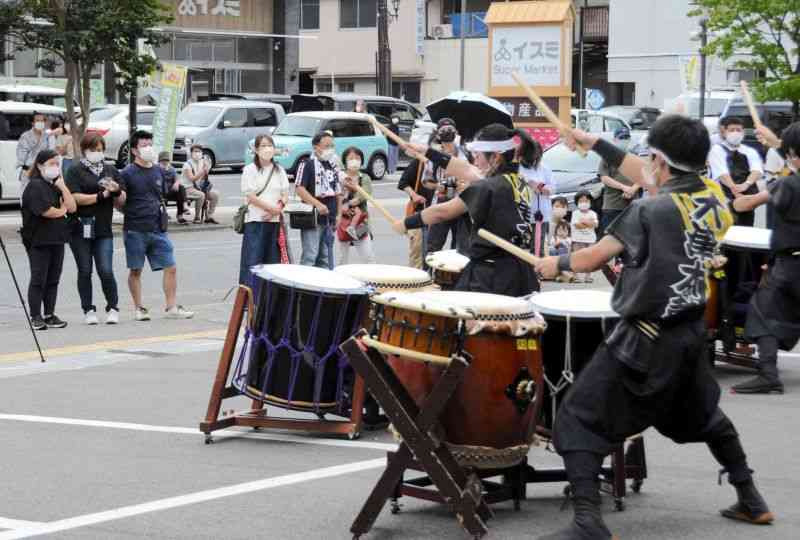 復興を願って開かれたイベントで、太鼓の演奏に聞き入る地元住民ら＝3日、人吉市