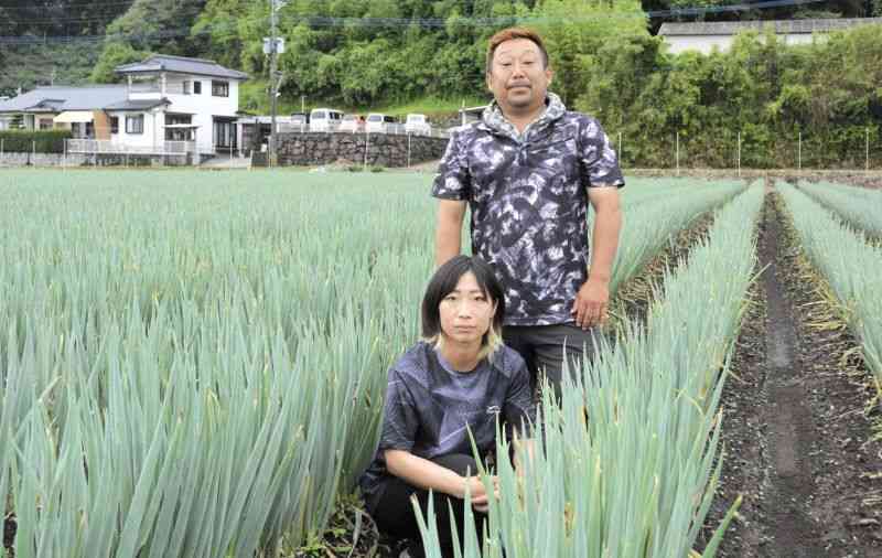 会社勤めから農家に転身し、白ネギなどを育てる中原誠さんと妻の香澄さん＝人吉市