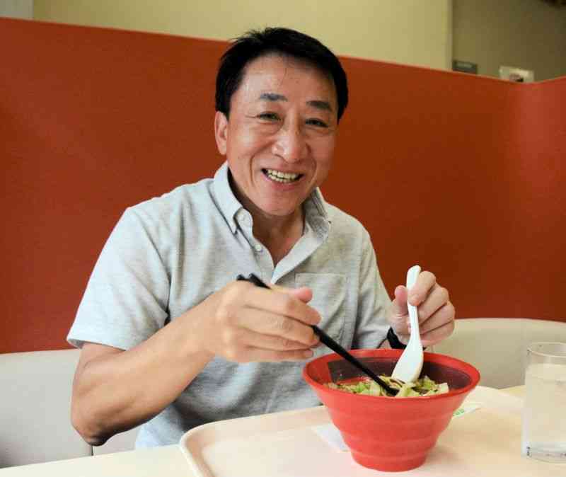 住友生命保険本社の社員食堂で「桂花ラーメン」に舌鼓を打つ泉忠和さん＝20日、東京・築地