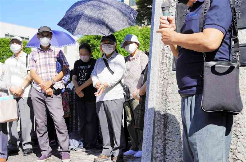 熊本地裁の判決後、支援者らに「勝訴に安どした」と語る原告の男性（右）＝3日、熊本市中央区
