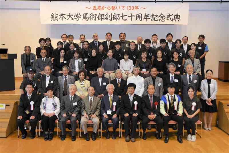 創部70周年記念式典で、写真に収まる熊本大馬術部の卒業生と現役学生ら＝熊本市中央区