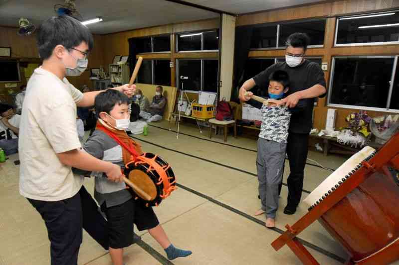 経験者から指導を受ける菰屋地区の打ち手＝荒尾市