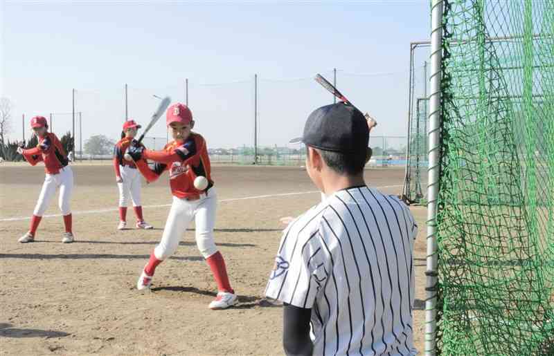 熊本西高生と一緒にバッティング練習する児童ら＝熊本市西区