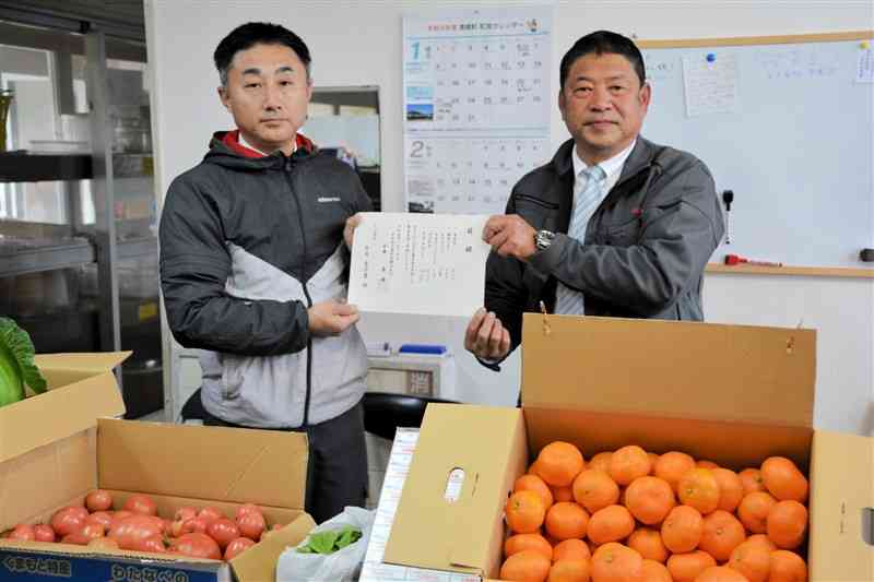 南関町の子ども食堂「とっぱ食堂」に野菜や果物を贈った玉名地方農業振興同友会の原靖会長（右）＝南関町