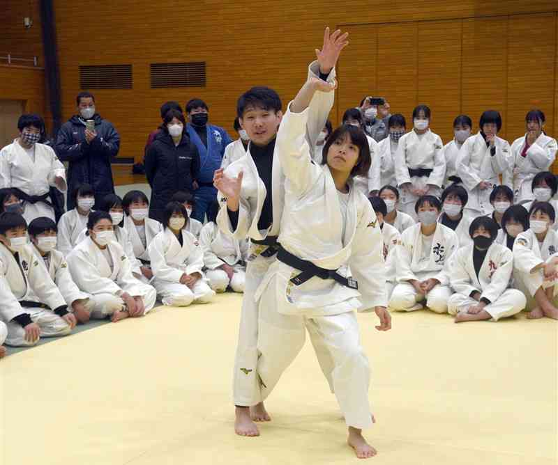 練習パートナーの森和輝さん（手前左）と組み、柔道の立ち技の手本を示す東京五輪金メダリストの阿部詩選手（同右）＝山鹿市