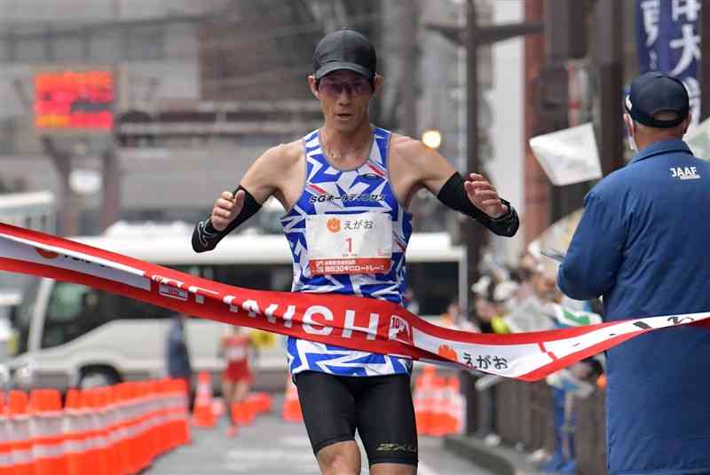 熊日30キロロードレースの男子1位でフィニッシュする佐藤悠基（SGホールディングス）＝19日午前、熊本市中央区のびぷれす熊日会館前（谷川剛）