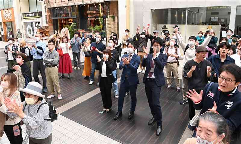 日本のWBC優勝をハヤカワスポーツ上通本店前のテレビで見届け、手をたたいて喜ぶ買い物客ら＝22日午前11時45分ごろ、熊本市中央区（石本智）