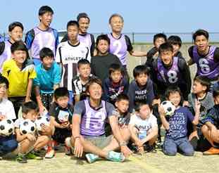 ロアッソ熊本の選手が開いた避難所の子どもたちとのサッカー教室。Ｊリーグの原博実・副チェアマン（後列左から４人目）も飛び入り参加した＝２０１６年４月１９日、益城町
