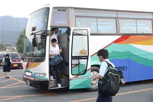 南阿蘇村と高森町が運行する代替バスを利用して通学する高校生ら＝５月３０日午後７時すぎ、高森駅