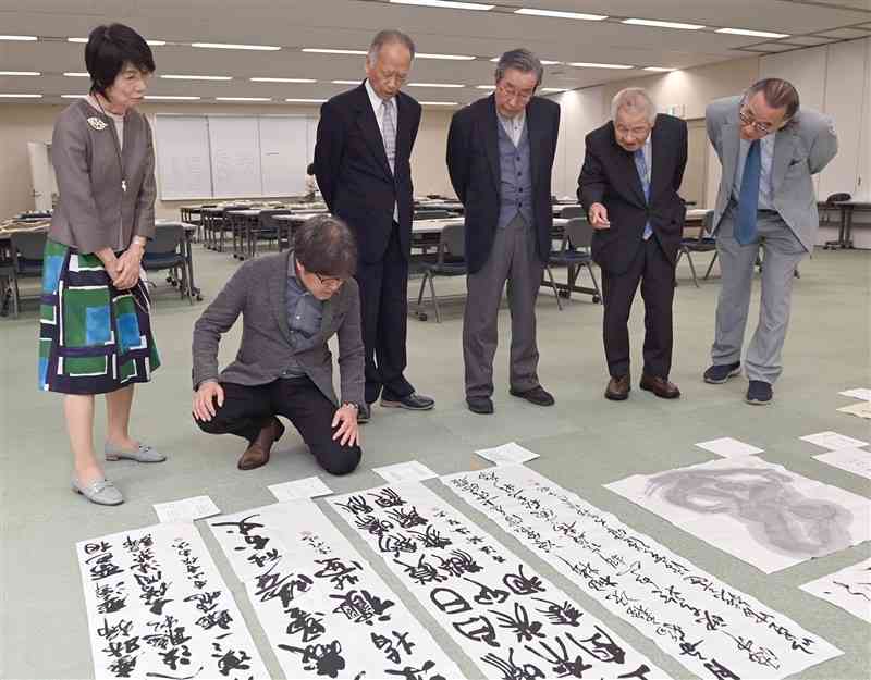 第42回熊日新鋭・学童書道展で、新鋭の部の応募作品を見る審査員たち＝18日、熊本市中央区の熊日本社（鹿本成人）