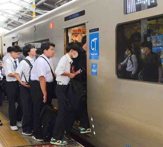 列車に乗り込む高校生や会社員で混み合うJR鹿児島線西熊本駅の上りホーム＝5月29日、熊本市南区