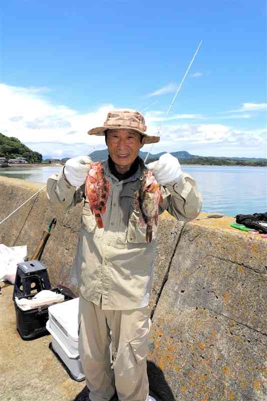 「いいサイズが釣れた」と笑顔でガラカブを見せる満尾幸喜さん＝上天草市大矢野町の蔵々漁港