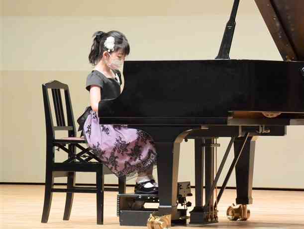 ピアノ部門の小学生低学年1次予選で課題曲を演奏する出場者＝熊本市中央区