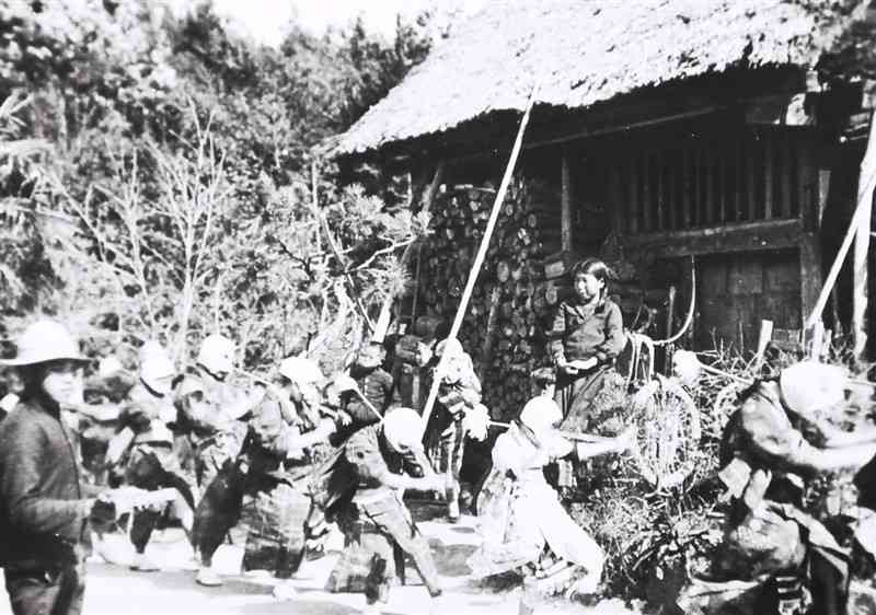 深田小学校の落成式のため、にわか踊りを練習する荒茂部落の女性たち。須恵村の平山から来た左端の男性が拍子木で拍子を取っている＝1936年3月