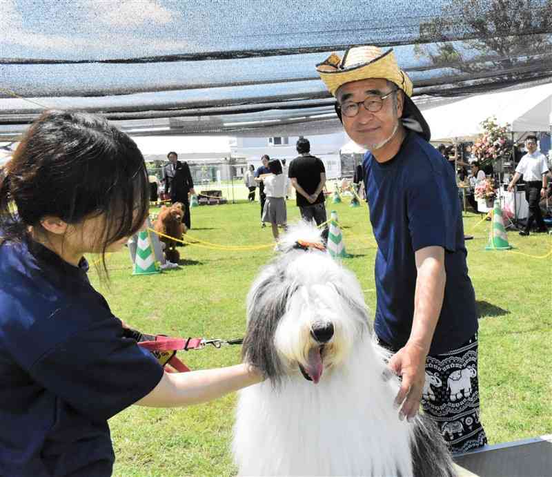 カメラマンとして全国のドッグショーを巡る田口一温さん（右）＝南関町