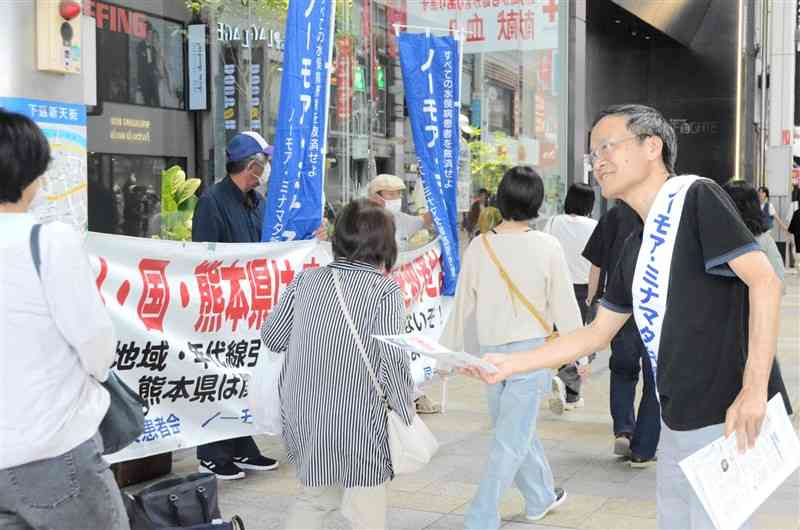 街頭活動で早期救済に向け支援を呼びかける参加者＝1日、熊本市中央区