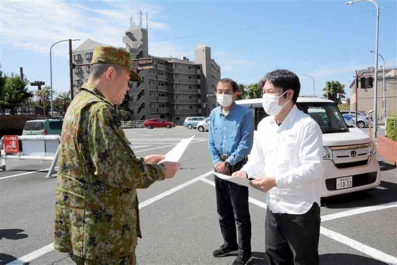 日米共同実動訓練の中止を求め、要請書を提出する県平和委員会と「いのちとくらし・平和を守る熊本ネットワーク」のメンバー（右）＝6日、熊本市東区