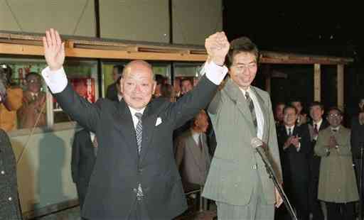細川知事(右)と手を結び、支持者らの歓声と拍手に両手をかかげる福島氏＝1991年1月27日、熊本市