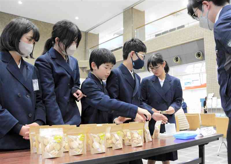 自ら育てた米で作った米粉クッキーを販売する松橋小の6年生＝1日、宇城市