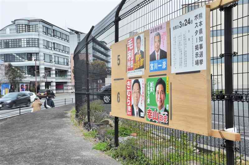 熊本県知事選に立候補した4人のポスターが張られた掲示板＝11日、熊本市