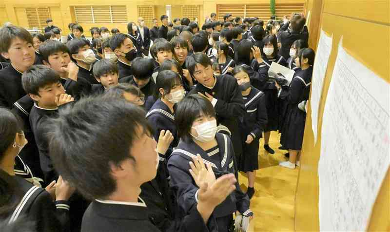 発表されたクラス分けを見る生徒たち＝11日、長洲町