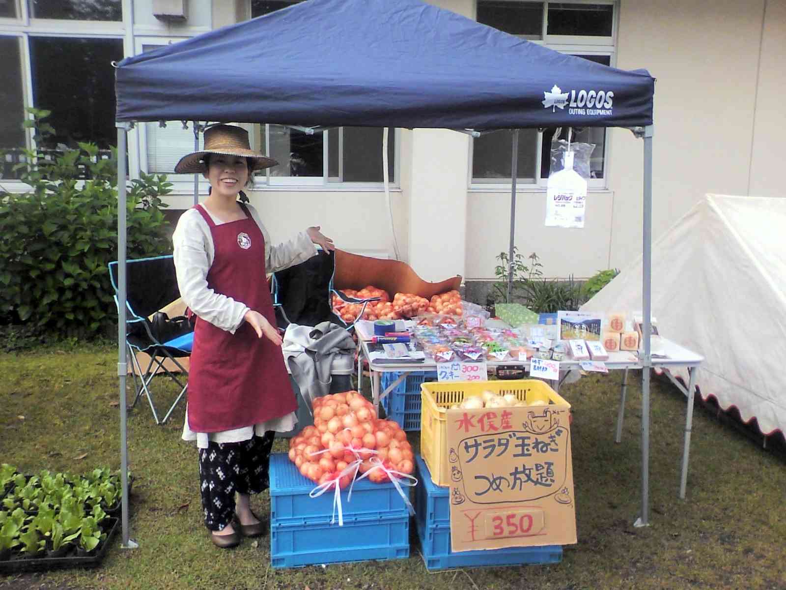 養生園祭の愛林館ブースで、サラダタマネギや加工品などを紹介するスタッフの村田佐代子さん＝2013年、菊池養生園