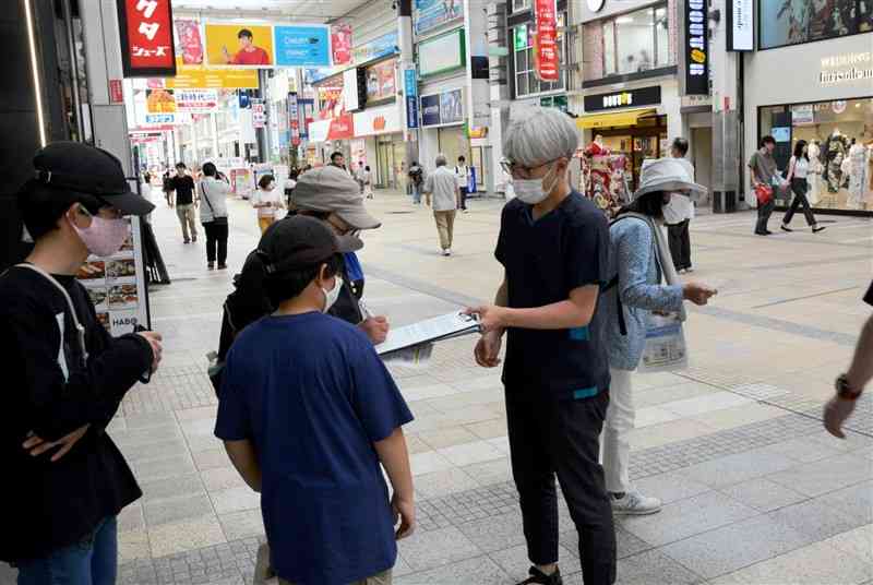 熊本労災病院の産科再開を求めて署名を求める市民団体のメンバー（右と中央）＝7日、熊本市中央区