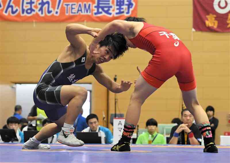 【レスリング少年男子グレコローマンスタイル51キロ級準決勝】相手と競り合う熊本の古閑迫（左、小川工高）＝嬉野市中央体育館