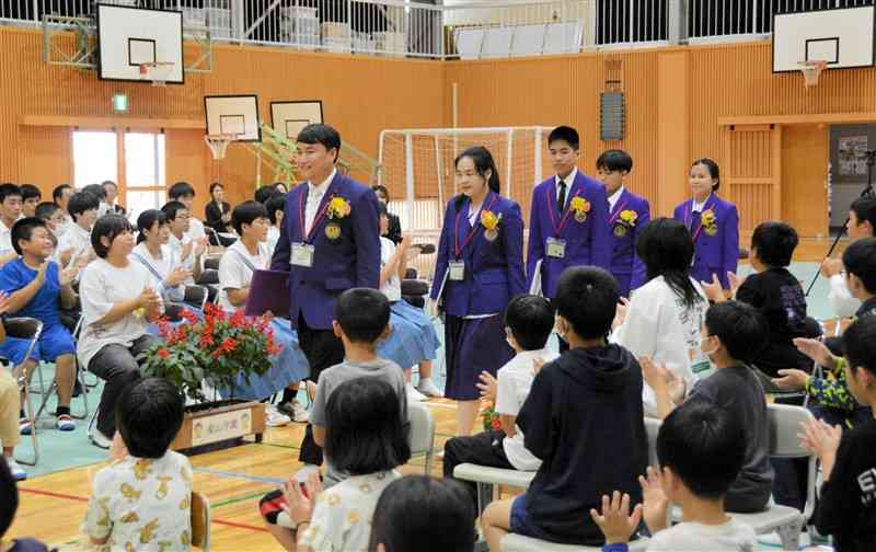 産山学園の児童生徒らの歓迎を受けるタイの生徒ら＝7日、産山村