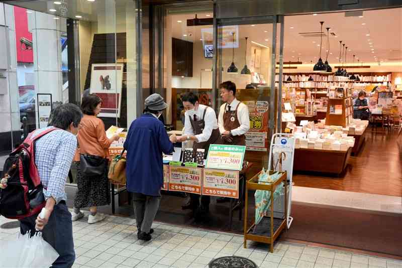 長崎書店前に設けられたプレミアム付き図書券の販売ブース＝1日、熊本市中央区