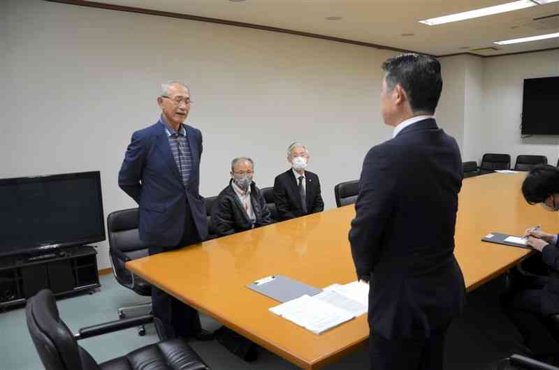 菊水南小跡地の買い戻しを求める要望書と署名を町に提出する蜻浦区の横田浩さん（左端）ら＝26日、和水町