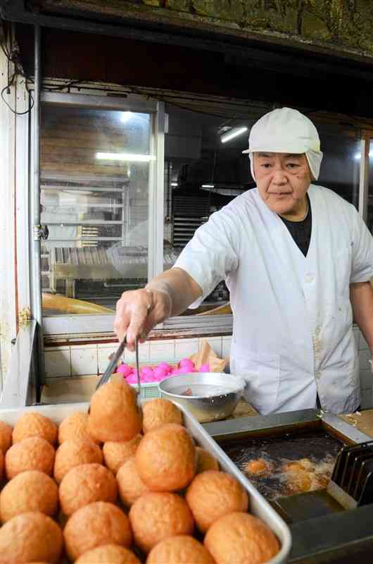 牛深名物の「ばくだん」を揚げる原光生さん＝＝26日、天草市