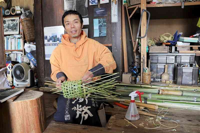 作業場で竹細工を製作する小川鉄平さん＝宮崎県日之影町