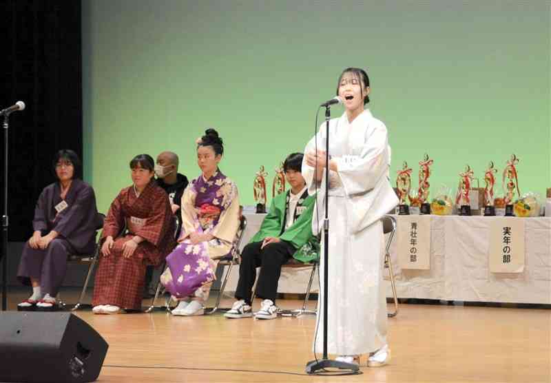 高らかに歌声を披露する第16回八代おざや節全国大会の出場者＝9日、八代市