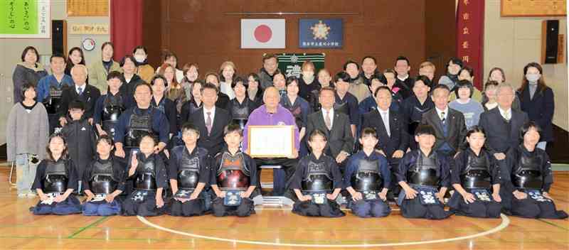 記念写真に納まる壺川剣友会のメンバーら＝15日、熊本市中央区